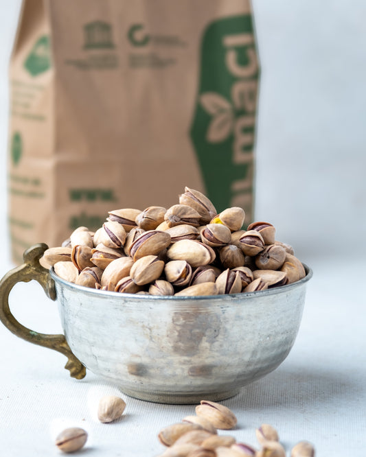 Yakından görünüm metal kasede Antep fıstığı, dalında kendiliğinden açılan ana çıtlak, az tuzlu ve çifte kavrulmuş taze mahsül.