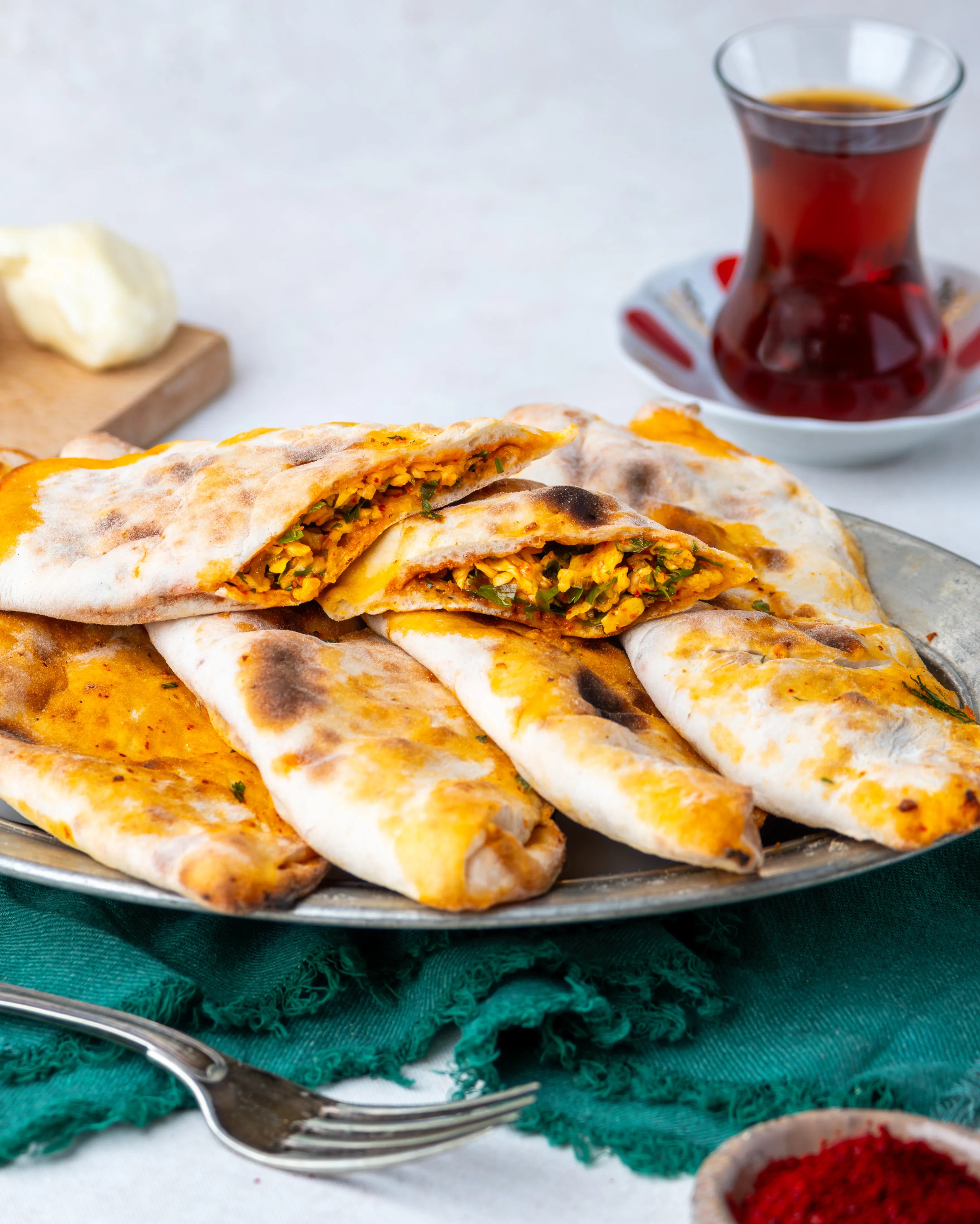İkiye bölünmüş peynirli börek, içinde maydanoz, pul biber ve yumurta ile harmanlanmış özel peynir harcı bulunan, taş fırın pidesi.