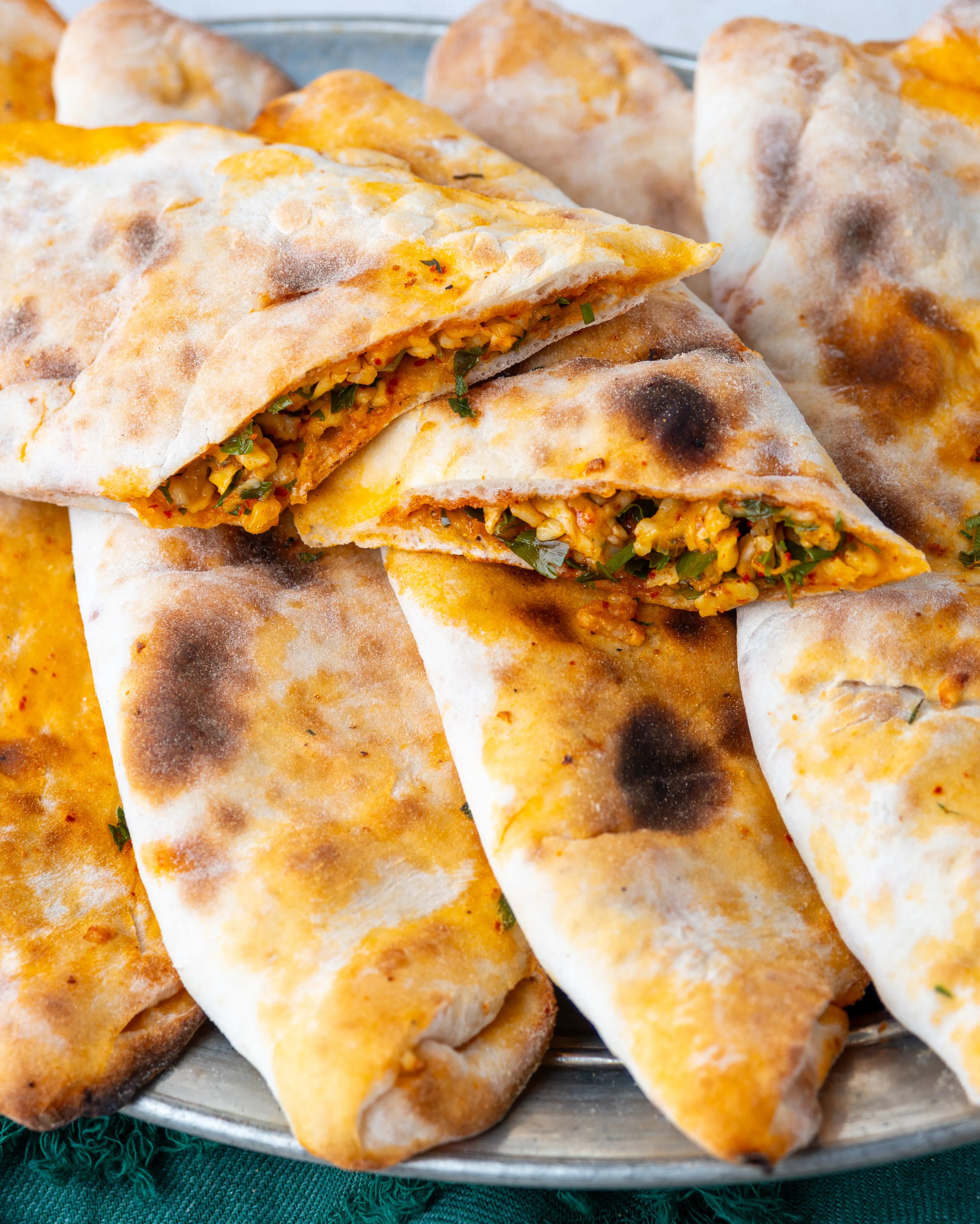 İkiye bölünmüş peynirli börek, içinde maydanoz, pul biber ve yumurta ile harmanlanmış özel peynir harcı bulunan, taş fırın pidesi.