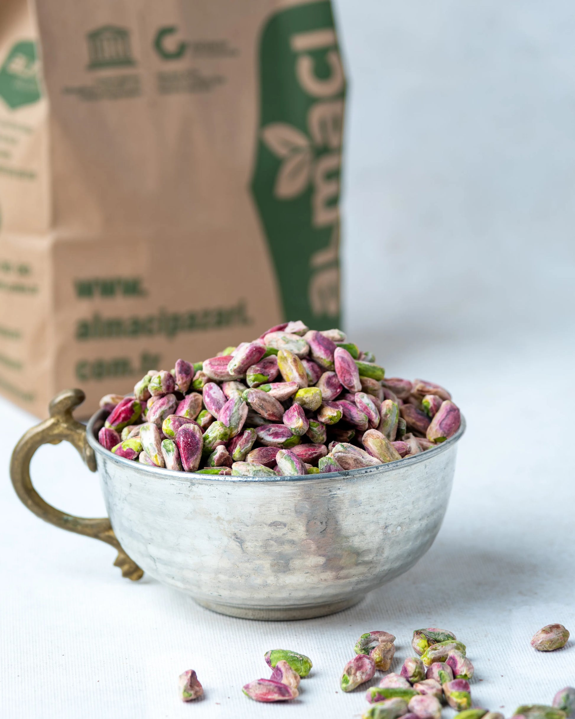 Yakından görünüm kırmızı iç Antep fıstığı, pembe zarlı ve yeşil içli tam olgunlaşmış ayıklanmış kuruyemiş taneleri.