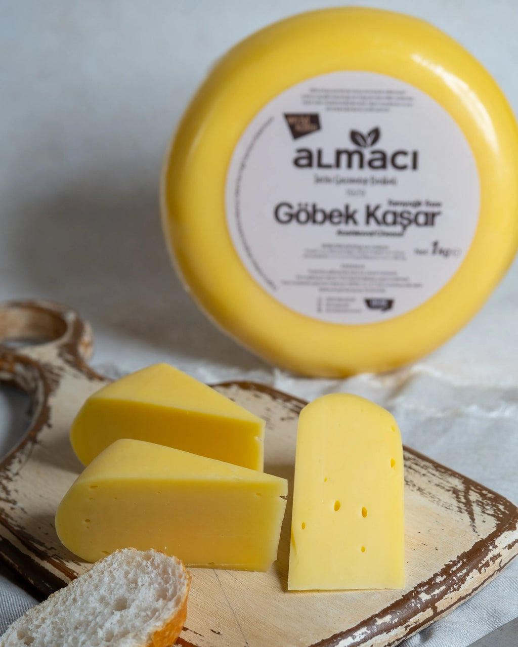 Almacı Pazarı yuvarlak göbek kaşar peyniri ve dilimleri, tam yağlı süt içeriğiyle tostlarda mükemmel eriyen taze kaşar.