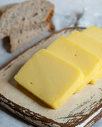 Paketli Almacı Pazarı 1 kg taze kaşar peyniri, tam yağlı inek sütünden üretilen, tost ve pizzalar için ideal eriyen blok peynir.