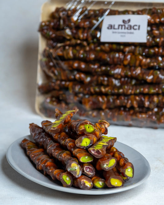 Yakından görünüm kesilmiş Antep fıstıklı sucuk, yoğun zümrüt yeşili boz iç fıstık dolgulu ve doğal üzüm pekmezli enerji deposu.